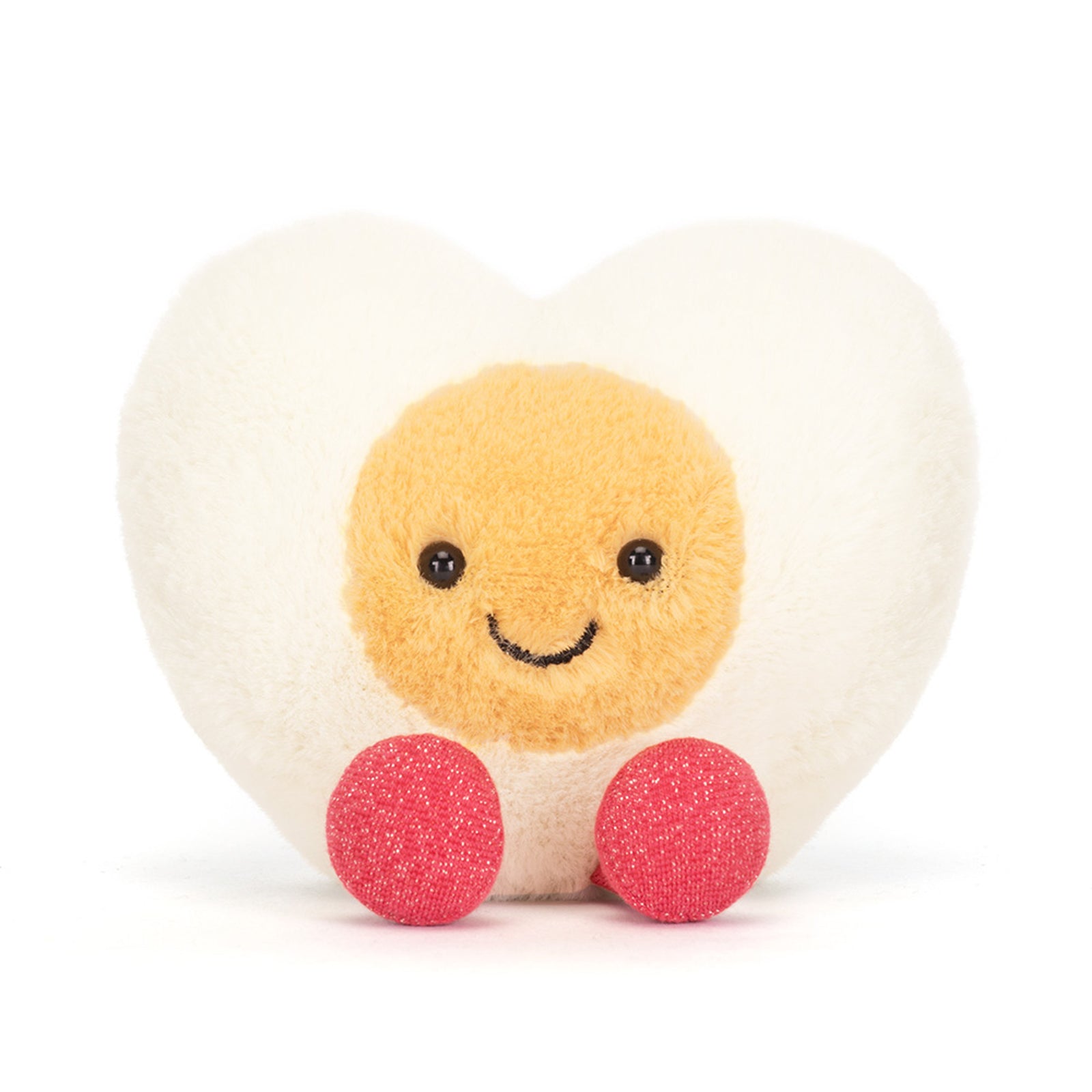 Front view of a Jellycat white egg heart-shaped plush toy with a yellow smiling face and red sparkly feet on a white background
