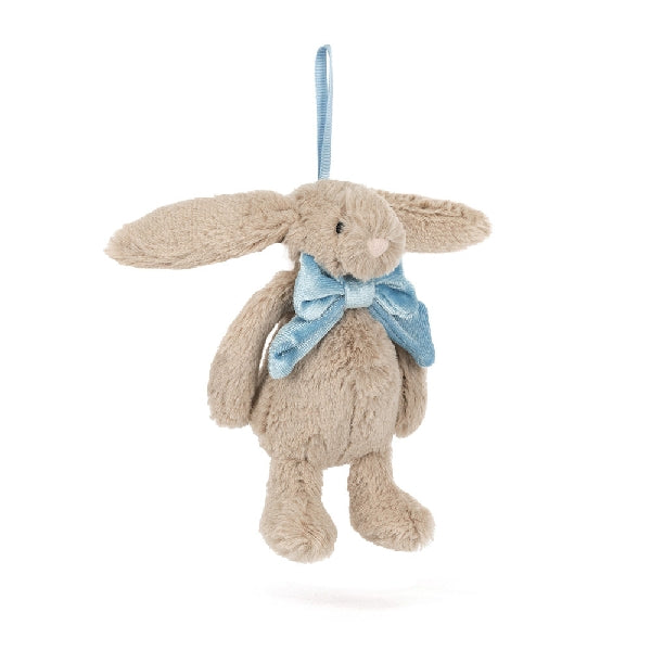Front view of a Jellycat beige plush bunny ornament with a blue bow on a white background