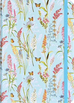 A small journal with a floral and butterfly pattern on a light blue background, featuring gold foil embellishments.