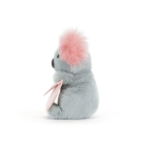 Side view of a Jellycat grey plush koala toy with pink ears holding a pink envelope on a white background