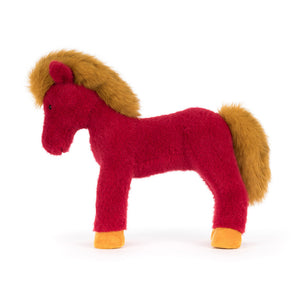 Side view of a Jellycat plush toy horse with red body and yellow mane and hooves on a white background