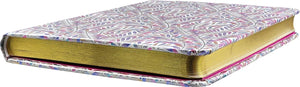 Hardback notepad with gilded gold edges lying flat on a white background. 