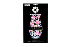 Pink and blue floral-patterned expandable vase on a black packaging background with 'Moggy' branding.