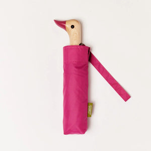 Pink umbrella with a wooden duck handle on a white background.