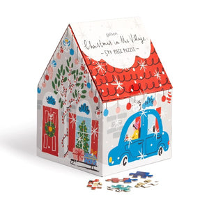 house-shaped puzzle box. it has cute illustrations of a grey-brick house decorated with red, black , green, blue, pink, and green drawings for Christmas