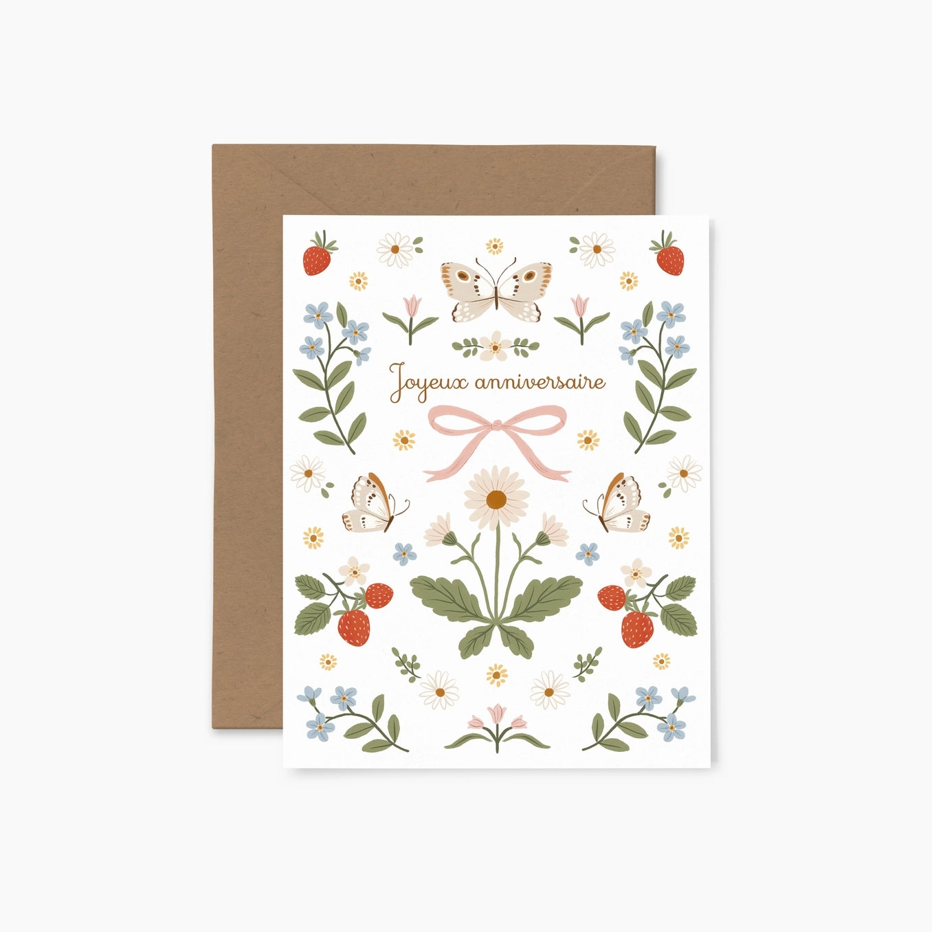 Greeting card featuring colourful illustrations of flowers, butterflies, strawberries and a bow along with the text  'Joyeux Anniversaire' on a white background with a brown envelope.