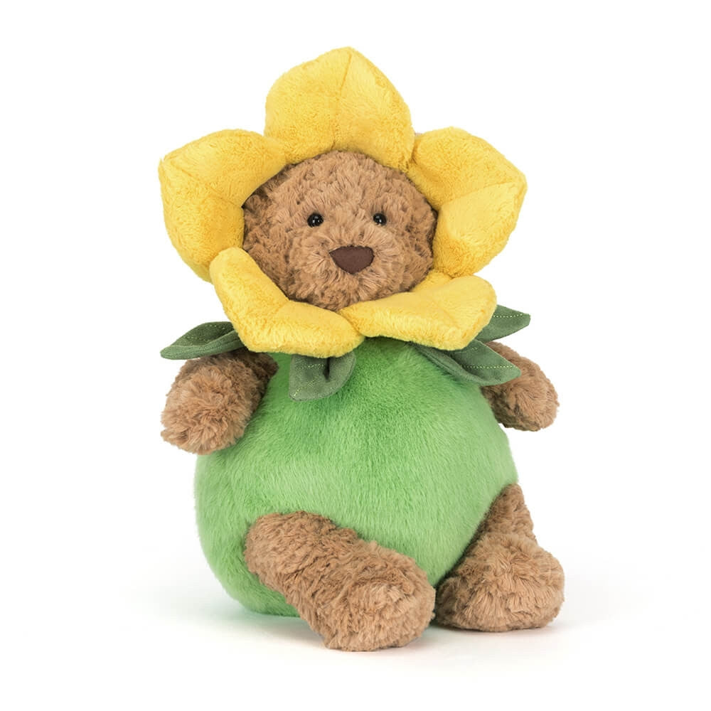 Front view of a brown Jellycat bear plush wearing a green and yellow daffodil outfit on a white background
