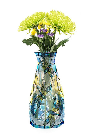 Expandable vase with a yellow and blue dragonfly design filled with a bouquet of flowers on a white background. 