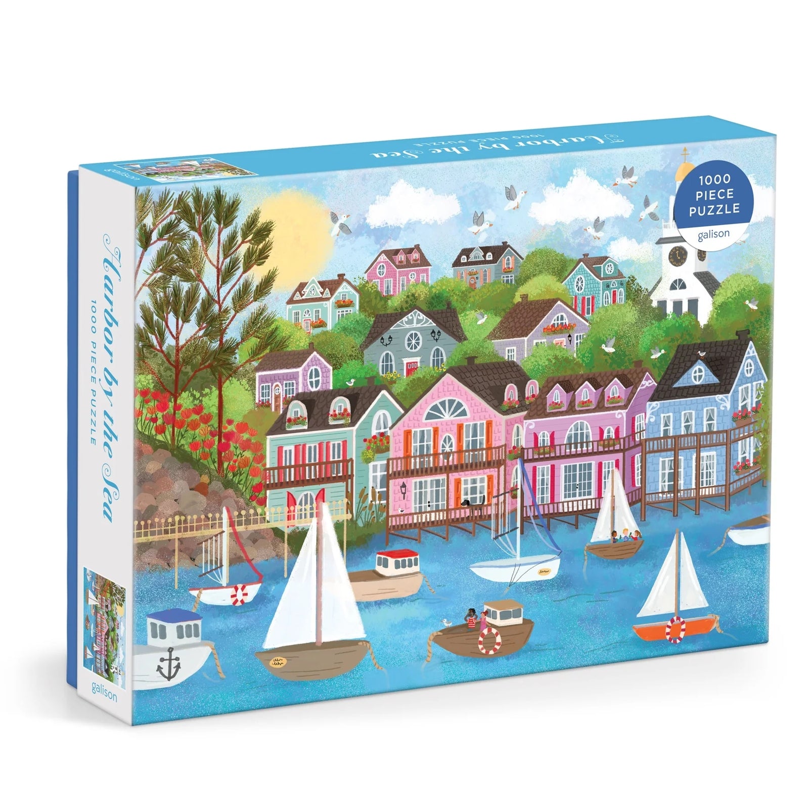 Puzzle box featuring a colourful illustration of a harbour filled with boats. The harbour is surrounded by lots of colourful houses and greenery. The text 'Harbour by the Sea' is printed on the side of the box.