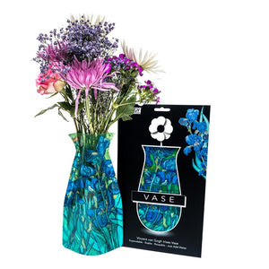 Expandable vase with a blue and green design based on Van Gogh's Irises. The vase is filled with a bouquet of flowers and sits beside it's packaging with Modgy branding.