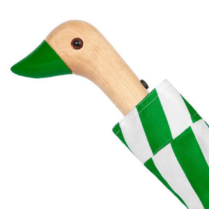 Closeup of the handle of an umbrella with a green and white checkered pattern and a duck head shaped handle on a white background. 