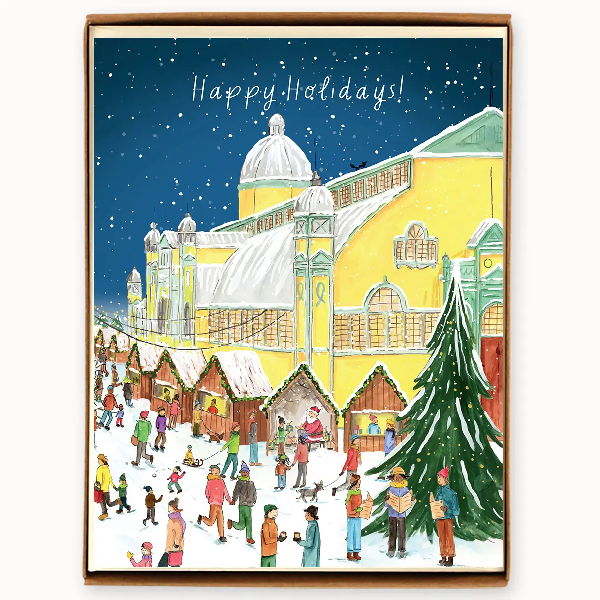 A boxed holiday card featuring an illustration of Lansdowne Park in Ottawa with a Christmas theme, including people, trees, and a building with a snow-covered roof.