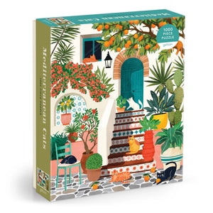 Puzzle box featuring an illustration of some cats lounging on a bright Mediterranean porch outside a house. The cats are surrounded by colourful potted plants and trees. The text 'Mediterranean Cats' is printed on the side of the box.