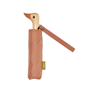Brown umbrella with a wooden duck head shaped handle on a white background. 