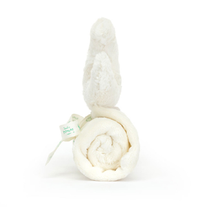 Side view of a Jellycat soft white moon soother with a smiling face on a white background