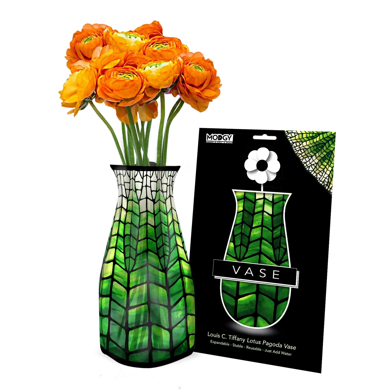 Green patterned expandable vase with a design based on 'Lotus Pagoda Vase' by Louis C. Tiffany filled with a bouquet of orange flowers. The vase is placed beside it's packaging with Modgy branding.