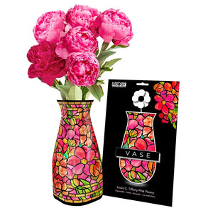 Expandable vase with a pink and orange floral design based on 'Pink Peony' by Louis C. Tiffany filled with a bouquet of pink flowers. The vase is placed beside it's packaging with Modgy branding.