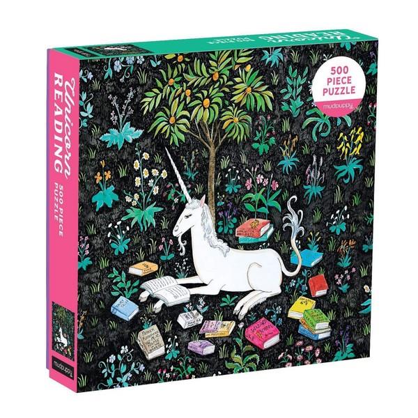 Puzzle box with an illustration of a unicorn lying under a tree, surrounded by colourful flowers, grass and books on a black background. 