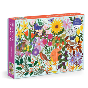 A jigsaw puzzle box with vibrant floral and seasonal artwork.