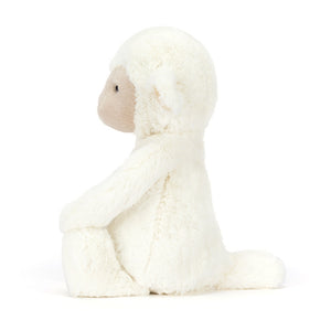 Side view of a white Jellycat lamb plush with a brown face on a white background