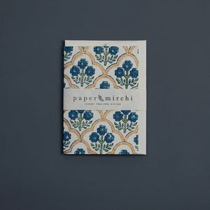 Cotton paper greeting card with a blue, green and gold botanical design on a blue background. 