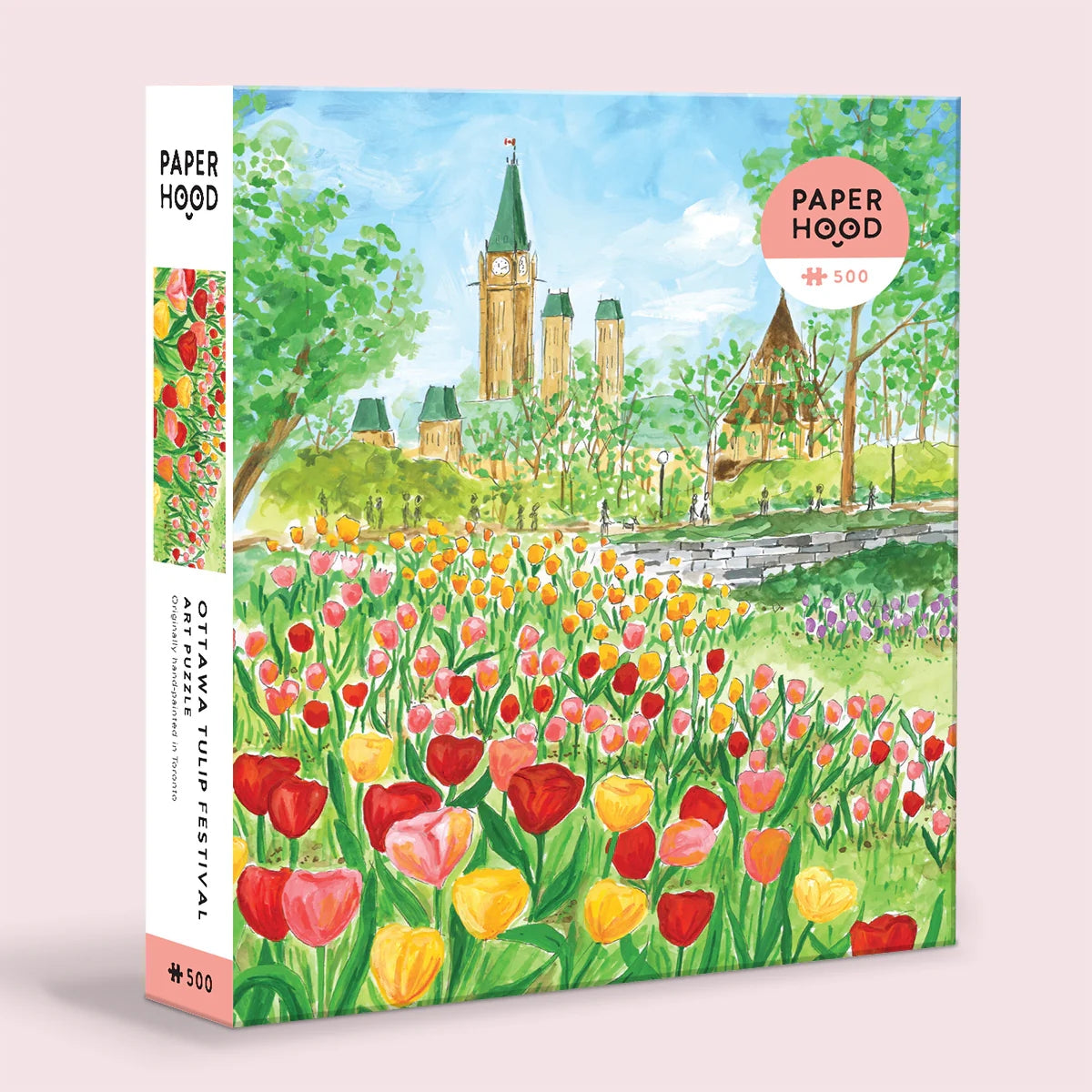 Jigsaw puzzle box featuring a beautiful illustrated scene from Ottawa's Tulip Festival. The box also shows the company branding.