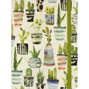 off-white journal with a green elastic band. illustrated on the cover are potted plants in a watercolour style
